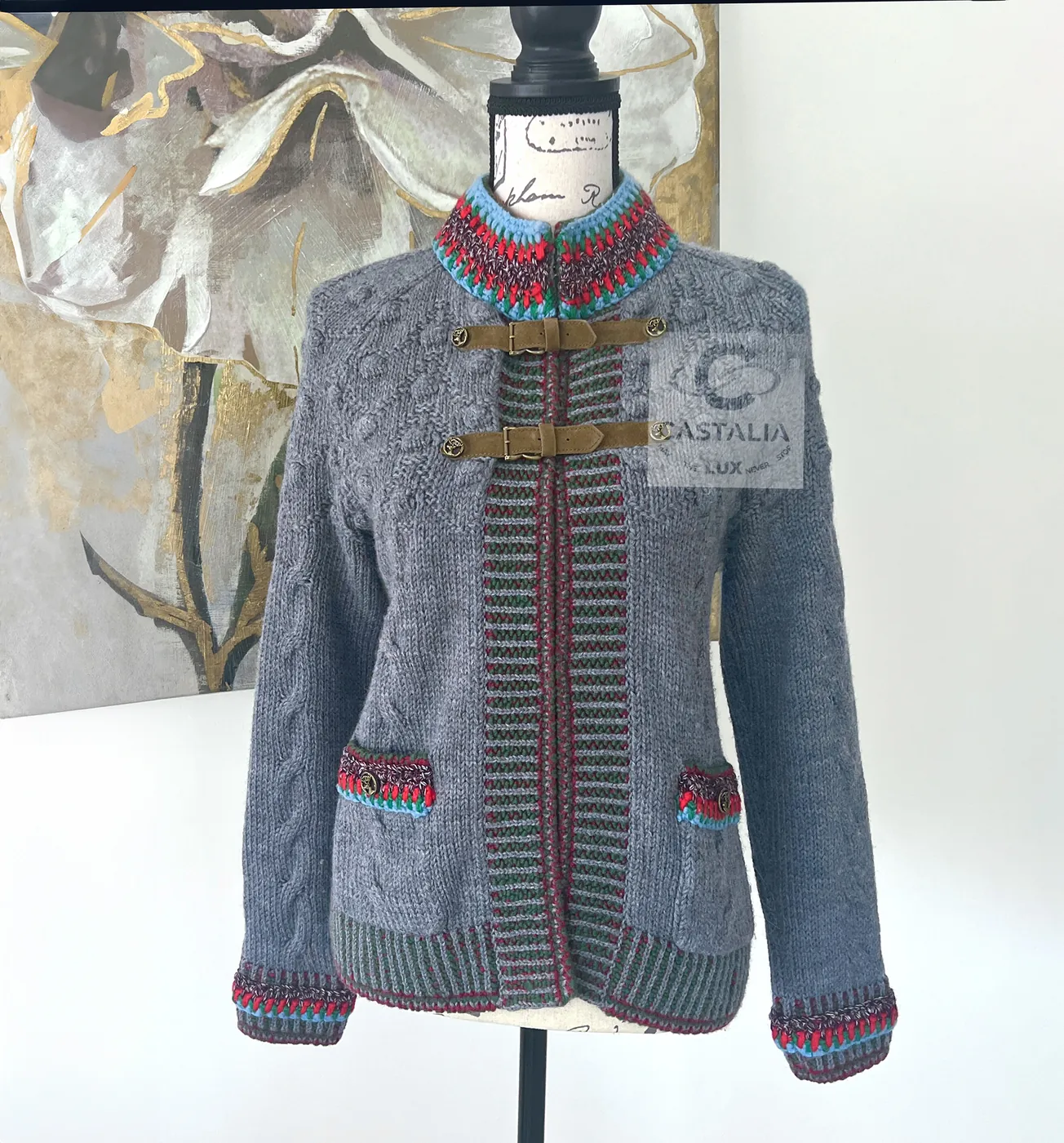 The Paris–Salzburg knit jacket: grey cable knit, a collar knitted in Tracht colours, suede straps fastened with stag-head buttons