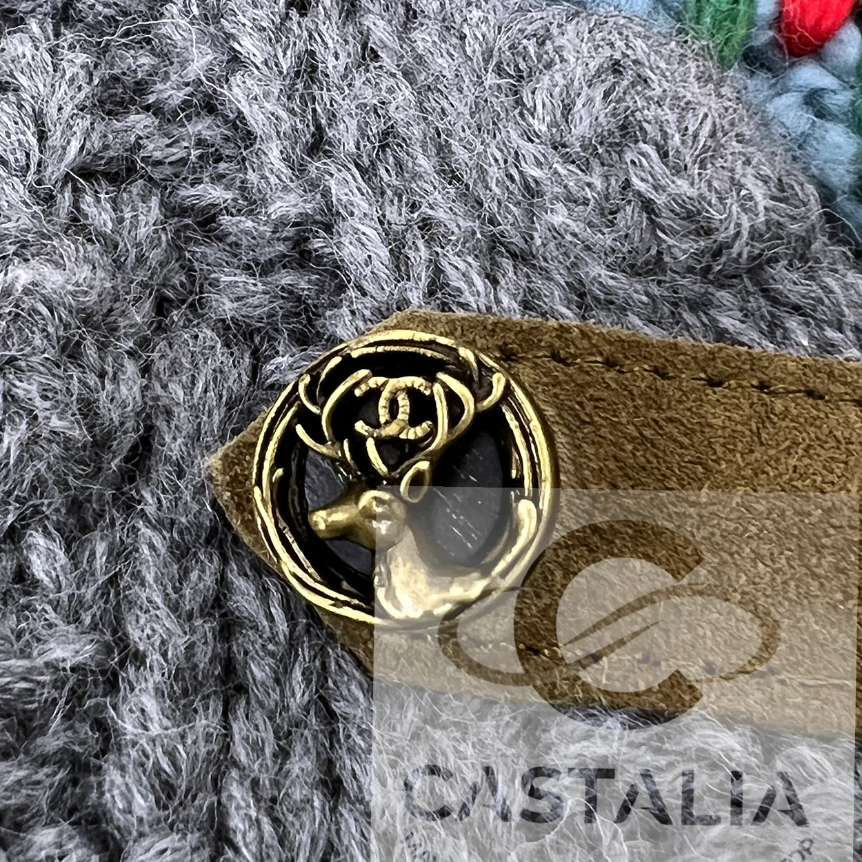 A stag-head button on the knit jacket: the same ring, the same stag, the same CC