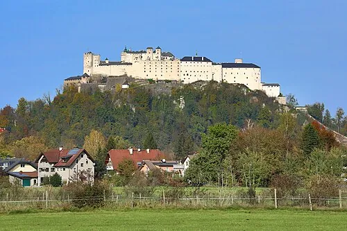The white fortress of Hohensalzburg on its wooded hill above the town