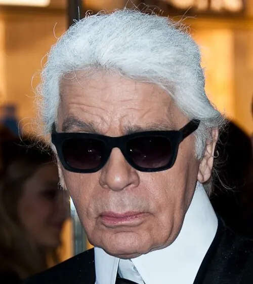 Karl Lagerfeld in 2014: white ponytail, dark glasses, high white collar
